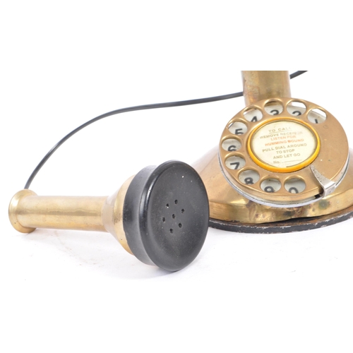 208 - An early 20th century circa 1920s brass candlestick telephone. The telephone being of brass construc... 