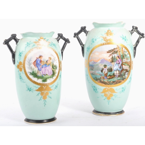 21 - A pair of 19th century Victorian Staffordshire mantel / table vases. Having a shaped rim, twin handl... 