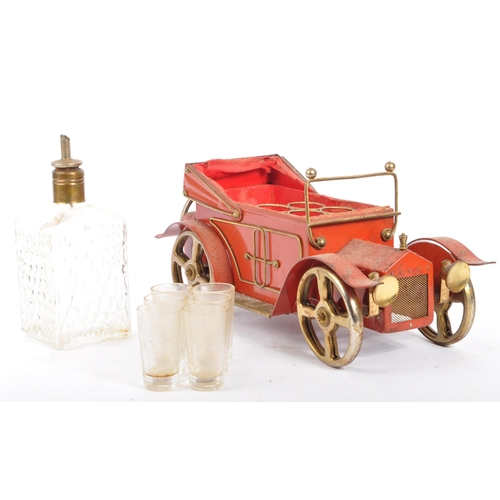 214 - A vintage mid 20th century novelty music box decanter set. The music box in the form of a car, featu... 