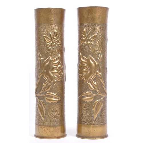 218 - A pair of early 20th century circa WWI hammered brass trench art vases. Each being of cylindrical fo... 