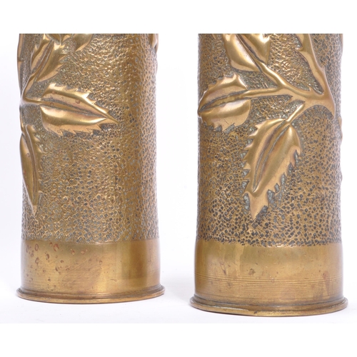 218 - A pair of early 20th century circa WWI hammered brass trench art vases. Each being of cylindrical fo... 