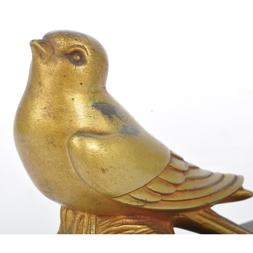 219 - A pair of 20th century Art Deco gilt metal and marble bookends. Each having gilt metal bird finial a... 