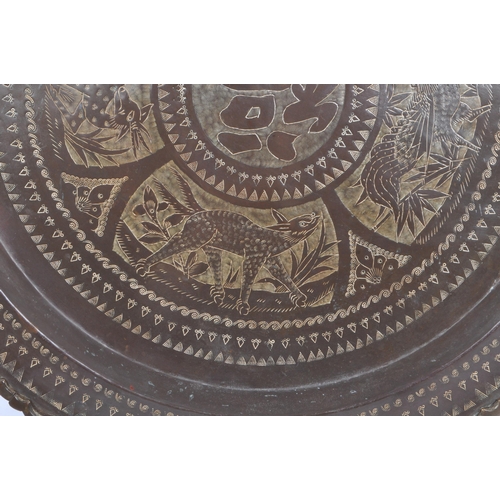 225 - A 20th century Chinese brass wall charger wall mounted tray. The charger having central Chinese char... 