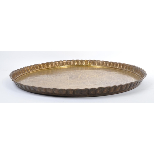 228 - A large 20th century Islamic Middle Eastern engraved brass tray wall charger. The tray having Islami... 