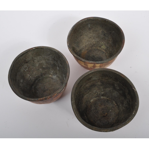 234 - A collection of 19th century Victorian copper and brass graduating saucepans. Varying sizes with bra... 