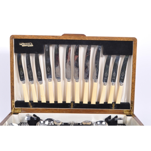 235 - Viners - A mid 20th century oak cased canteen of cutlery. Comprising of fifty pieces of stainless st... 