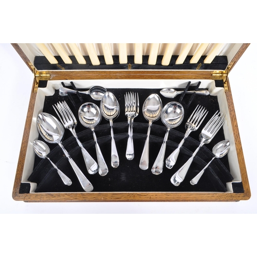 235 - Viners - A mid 20th century oak cased canteen of cutlery. Comprising of fifty pieces of stainless st... 