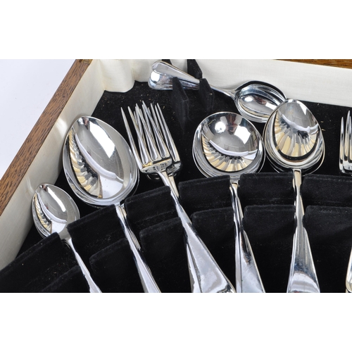 235 - Viners - A mid 20th century oak cased canteen of cutlery. Comprising of fifty pieces of stainless st... 