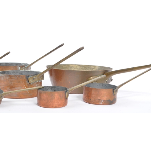 238 - A collection of 19th century Victorian copper and brass graduating saucepans. Varying sizes with bra... 