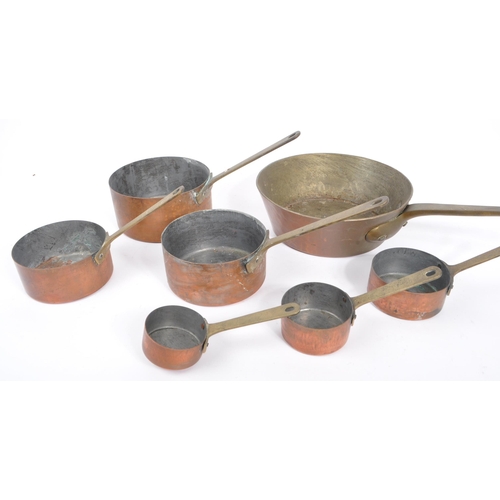 238 - A collection of 19th century Victorian copper and brass graduating saucepans. Varying sizes with bra... 