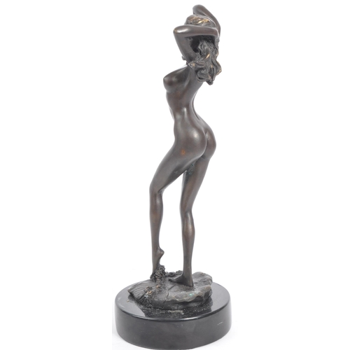 240 - A 20th century bronze metal female nude modelled to depict a female nude stood in contrapposto on a ... 