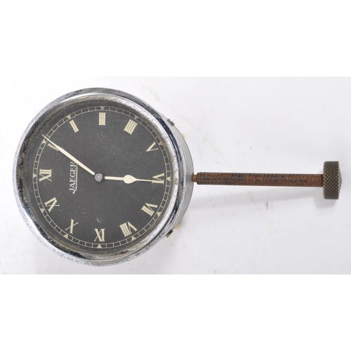 249 - Jaeger - A vintage chrome Jaeger car clock face having black face with white roman numeral to chapte... 