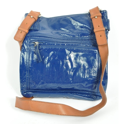 253 - A late 20th century Jaeger Lecoultre women's ladies navy patent leather handbag. The bag having a na... 