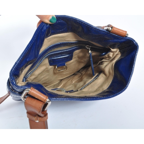 253 - A late 20th century Jaeger Lecoultre women's ladies navy patent leather handbag. The bag having a na... 