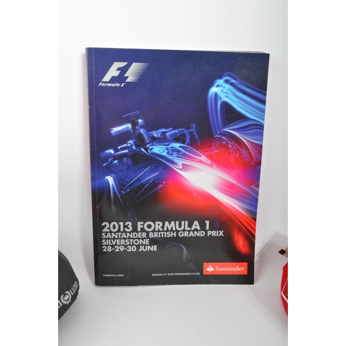 255 - A collection of contemporary formula one F1 memorabilia and clothing. The collection to include an o... 