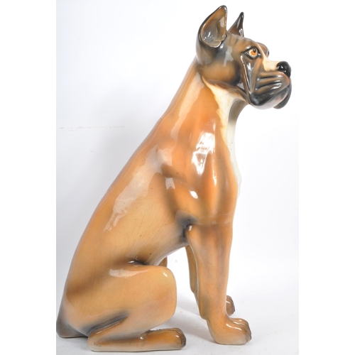 27 - A large vintage circa 1970s Italian ceramic boxer dog figurine. Modelled seated with hand painted fe... 