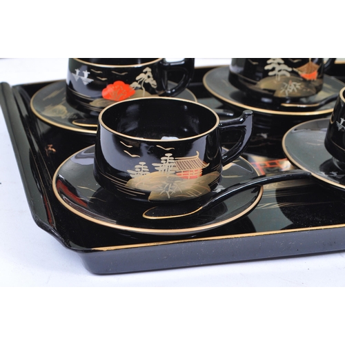 270 - A vintage 20th century boxed coffee and tea set. Of plastic construction with painted gilt decoratio... 