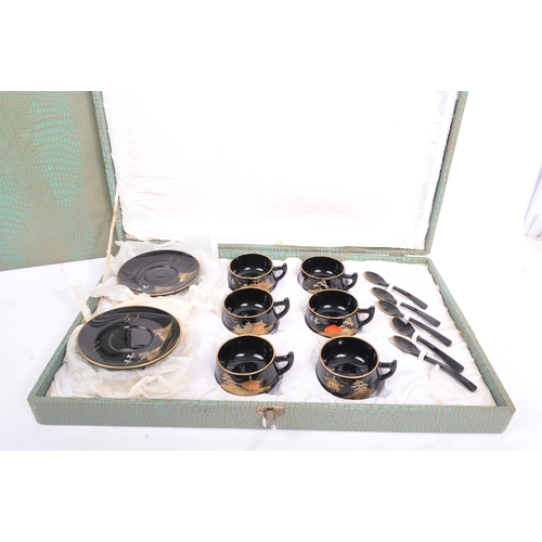 270 - A vintage 20th century boxed coffee and tea set. Of plastic construction with painted gilt decoratio... 