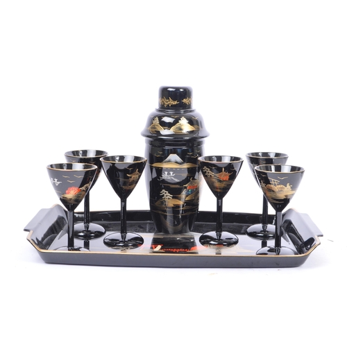 272 - A vintage 20th century cocktail drinks set. Comprising of a cocktail shaker with stemmed drinking gl... 