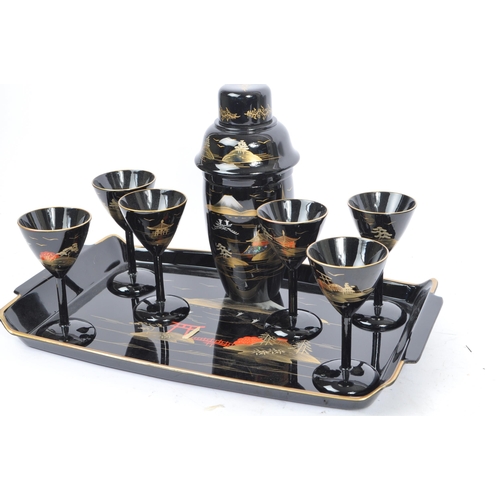 272 - A vintage 20th century cocktail drinks set. Comprising of a cocktail shaker with stemmed drinking gl... 