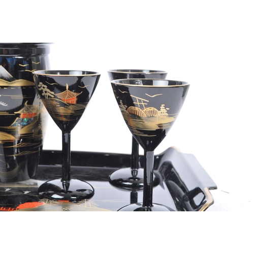 272 - A vintage 20th century cocktail drinks set. Comprising of a cocktail shaker with stemmed drinking gl... 