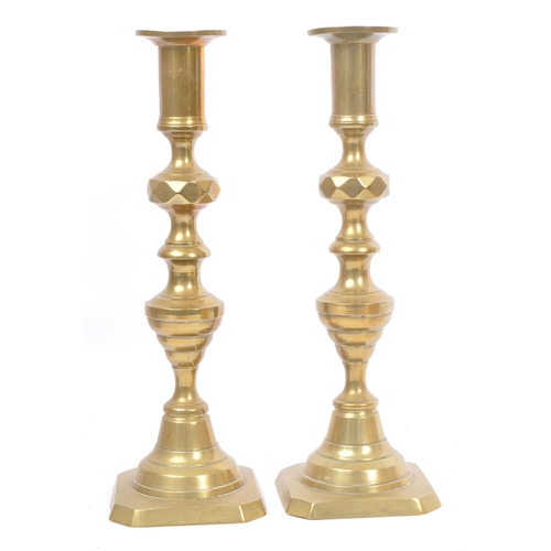 275 - A collection of late 19th / early 20th century brass candlesticks and jam pot. To include three matc... 