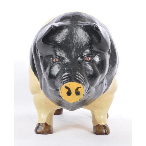 305 - A large 20th Century cast metal butcher piggy bank hand painted black and white. Plug on the undersi... 