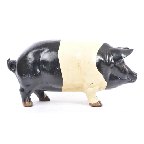 305 - A large 20th Century cast metal butcher piggy bank hand painted black and white. Plug on the undersi... 