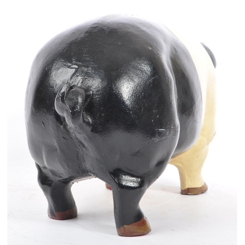 305 - A large 20th Century cast metal butcher piggy bank hand painted black and white. Plug on the undersi... 