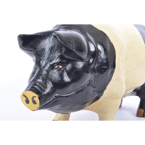 305 - A large 20th Century cast metal butcher piggy bank hand painted black and white. Plug on the undersi... 