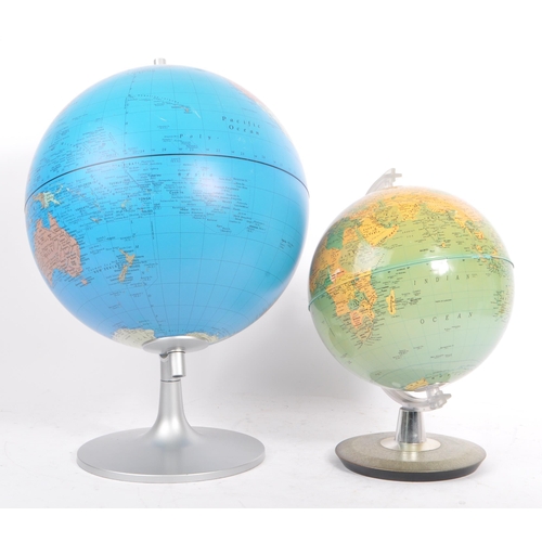 306 - Two 20th Century vintage world desktop globes both held upon silver circular bases. The larger one m... 