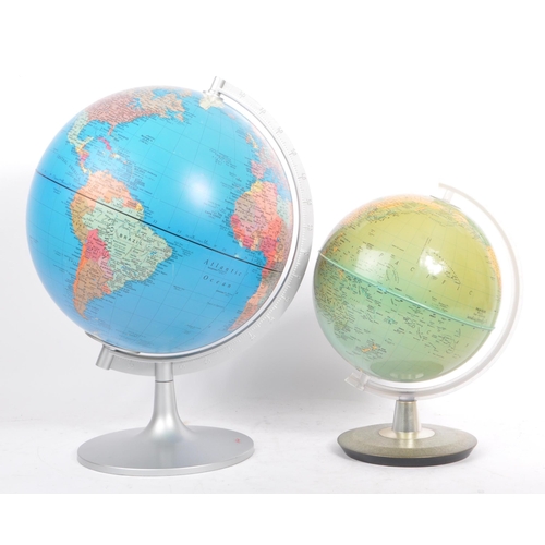 306 - Two 20th Century vintage world desktop globes both held upon silver circular bases. The larger one m... 