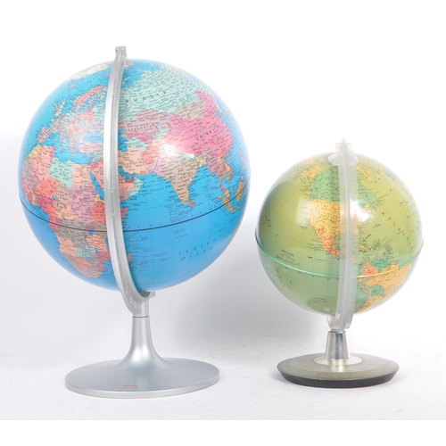 306 - Two 20th Century vintage world desktop globes both held upon silver circular bases. The larger one m... 