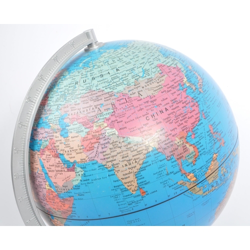 306 - Two 20th Century vintage world desktop globes both held upon silver circular bases. The larger one m... 