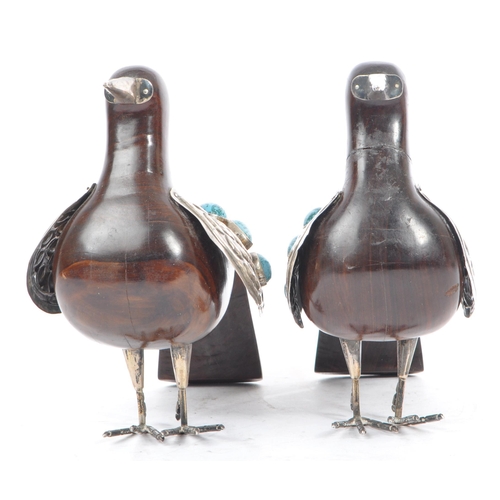 307 - A pair of 20th Century carved wood and silver folk art style candle holders in the form of two doves... 