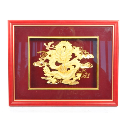 310 - A 20th Century Chinese gold plated dragon display held within a red velvet framed case. The dragon d... 