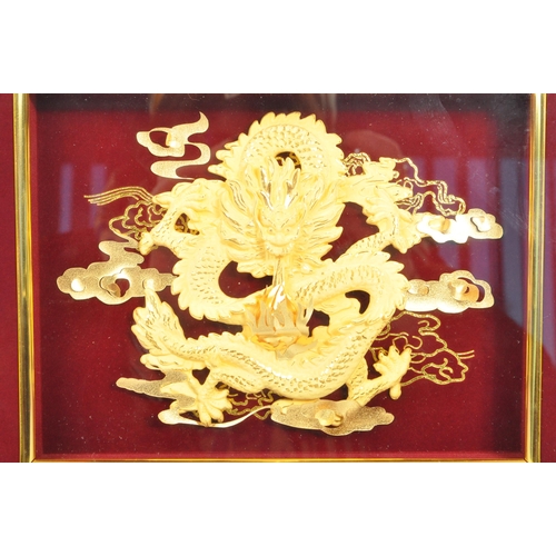 310 - A 20th Century Chinese gold plated dragon display held within a red velvet framed case. The dragon d... 