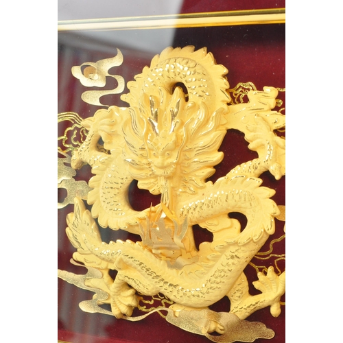 310 - A 20th Century Chinese gold plated dragon display held within a red velvet framed case. The dragon d... 