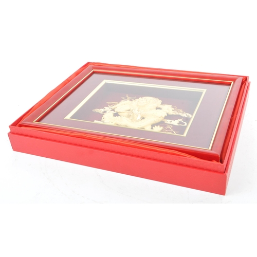 310 - A 20th Century Chinese gold plated dragon display held within a red velvet framed case. The dragon d... 