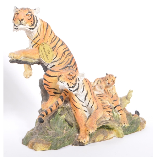 313 - A group of four resin 'tiger' figurines of the animal kingdom. To include two prowling tigers, playf... 