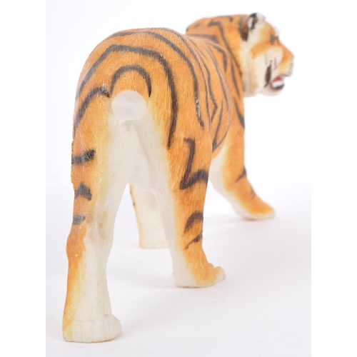 313 - A group of four resin 'tiger' figurines of the animal kingdom. To include two prowling tigers, playf... 