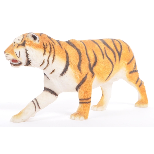 313 - A group of four resin 'tiger' figurines of the animal kingdom. To include two prowling tigers, playf... 