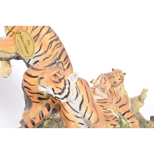 313 - A group of four resin 'tiger' figurines of the animal kingdom. To include two prowling tigers, playf... 