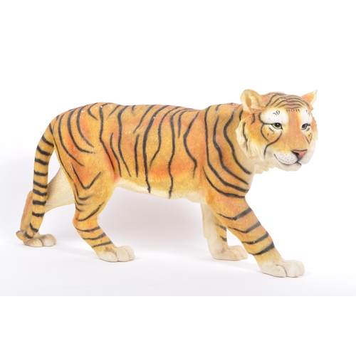 313 - A group of four resin 'tiger' figurines of the animal kingdom. To include two prowling tigers, playf... 