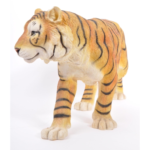 313 - A group of four resin 'tiger' figurines of the animal kingdom. To include two prowling tigers, playf... 