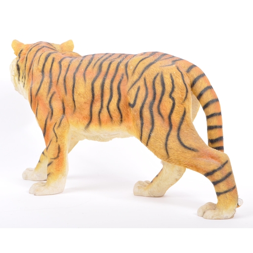 313 - A group of four resin 'tiger' figurines of the animal kingdom. To include two prowling tigers, playf... 