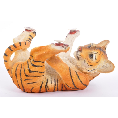 313 - A group of four resin 'tiger' figurines of the animal kingdom. To include two prowling tigers, playf... 