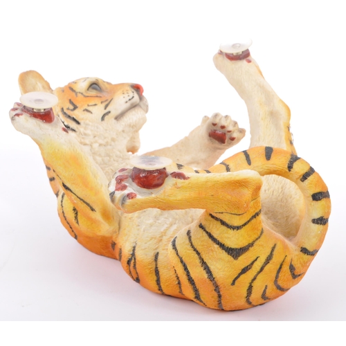 313 - A group of four resin 'tiger' figurines of the animal kingdom. To include two prowling tigers, playf... 