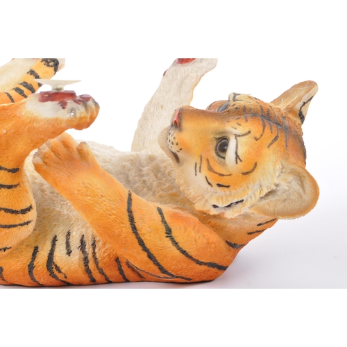 313 - A group of four resin 'tiger' figurines of the animal kingdom. To include two prowling tigers, playf... 