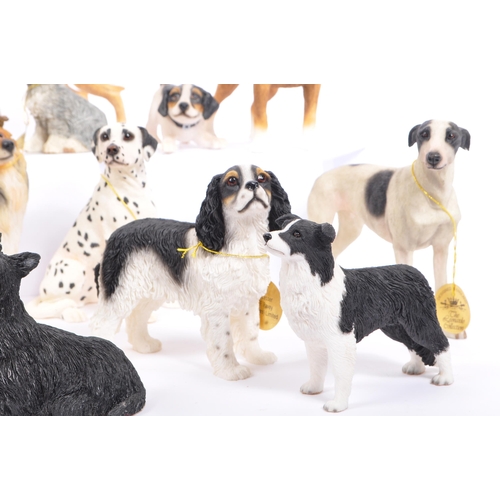 314 - A large collection of twenty unboxed dog study figurines by 'The Leonardo Collection' and others. To... 